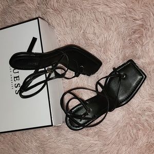 Women Black square toe heel sandals with ankle wrap.